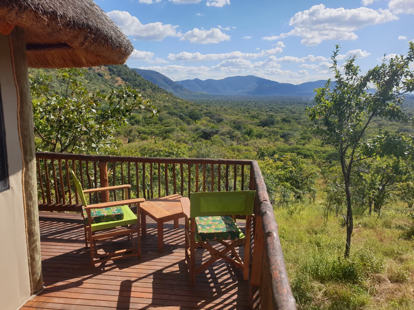 Private banda deck with safari chairs looking over the green valley